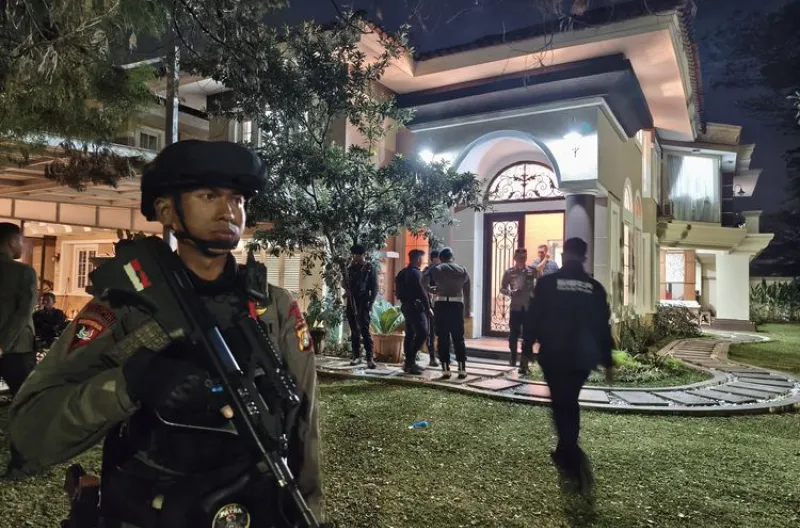 Penampakan rumah mewah yang digeledah dijaga ketat polisi di kawasan Sentul City, Kecamatan Babakan Madang, Kabupaten Bogor, Rabu (8/7/2026) malam.