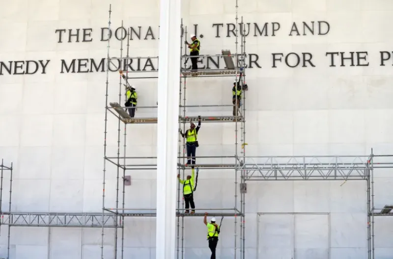 Para pekerja memasang perancah di depan papan nama John F Kennedy Center for the Performing Arts di Washington, DC, pada hari Jumat, 12 Juni 2026