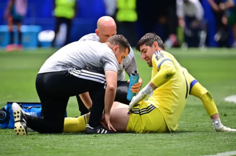 Thibaut Courtois dari Belgia menerima perawatan medis setelah mengalami cedera